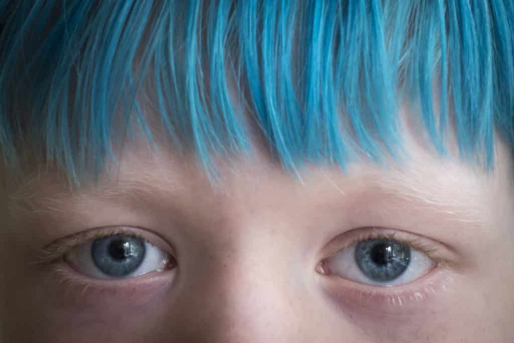 Small boy with blue hair.