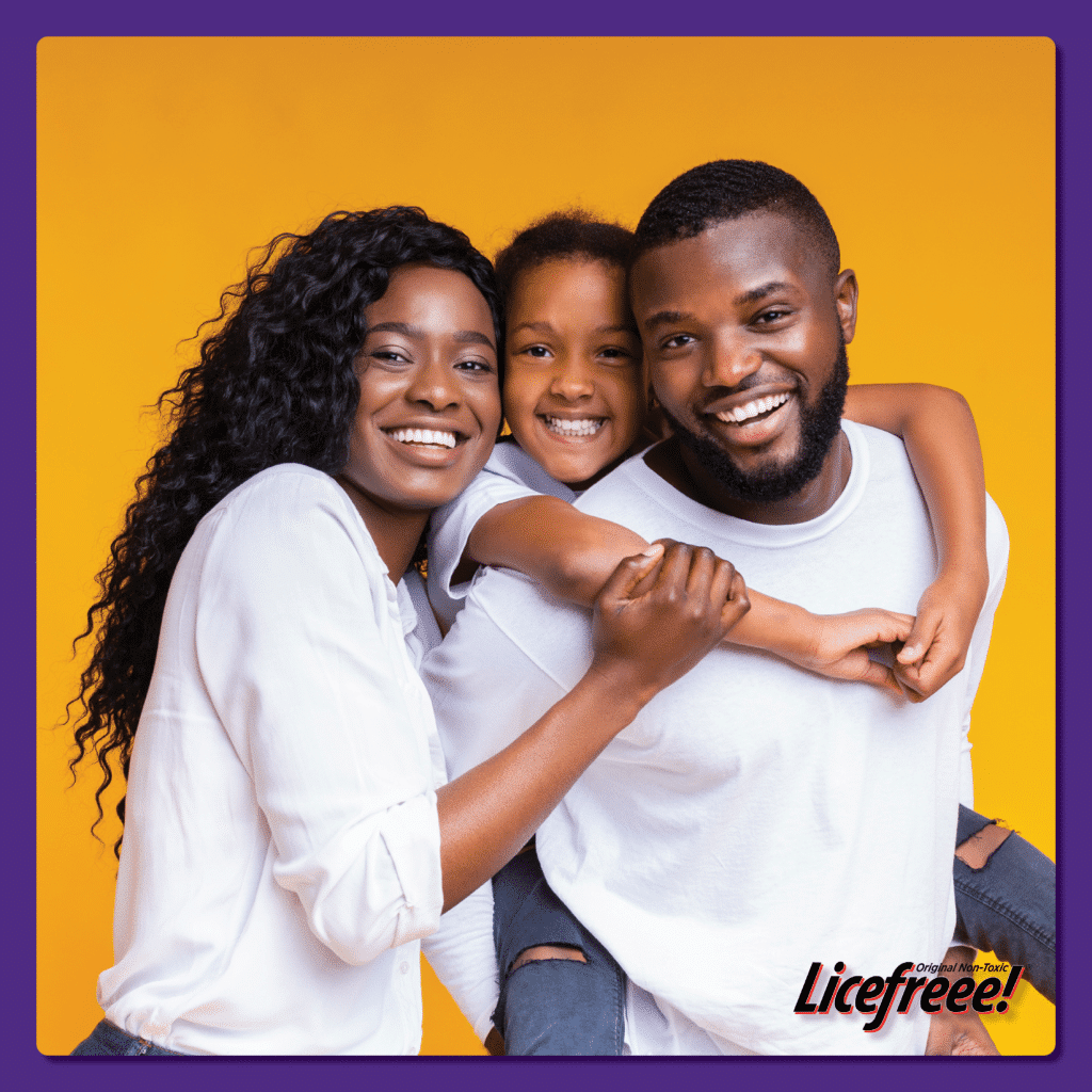 A happy family of black people consists of the parents and a daughter wearing white shirts.